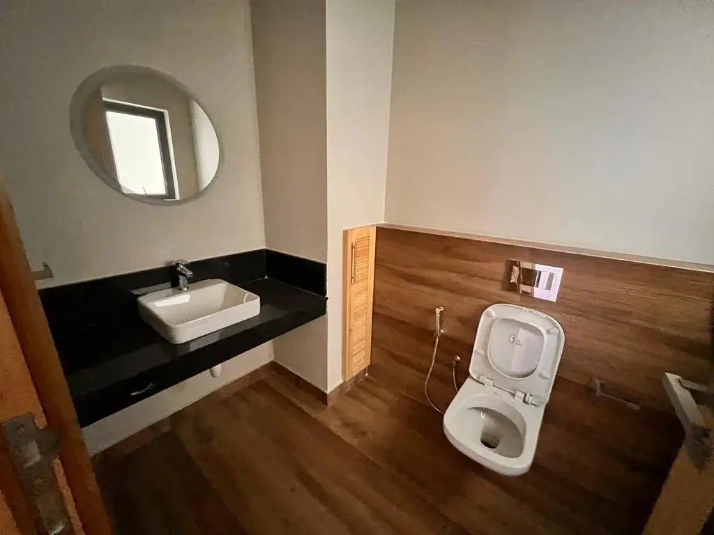 Modern bathroom with black countertop sink and white toilet