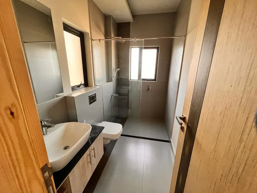Modern bathroom with vessel sink and walk-in shower enclosure