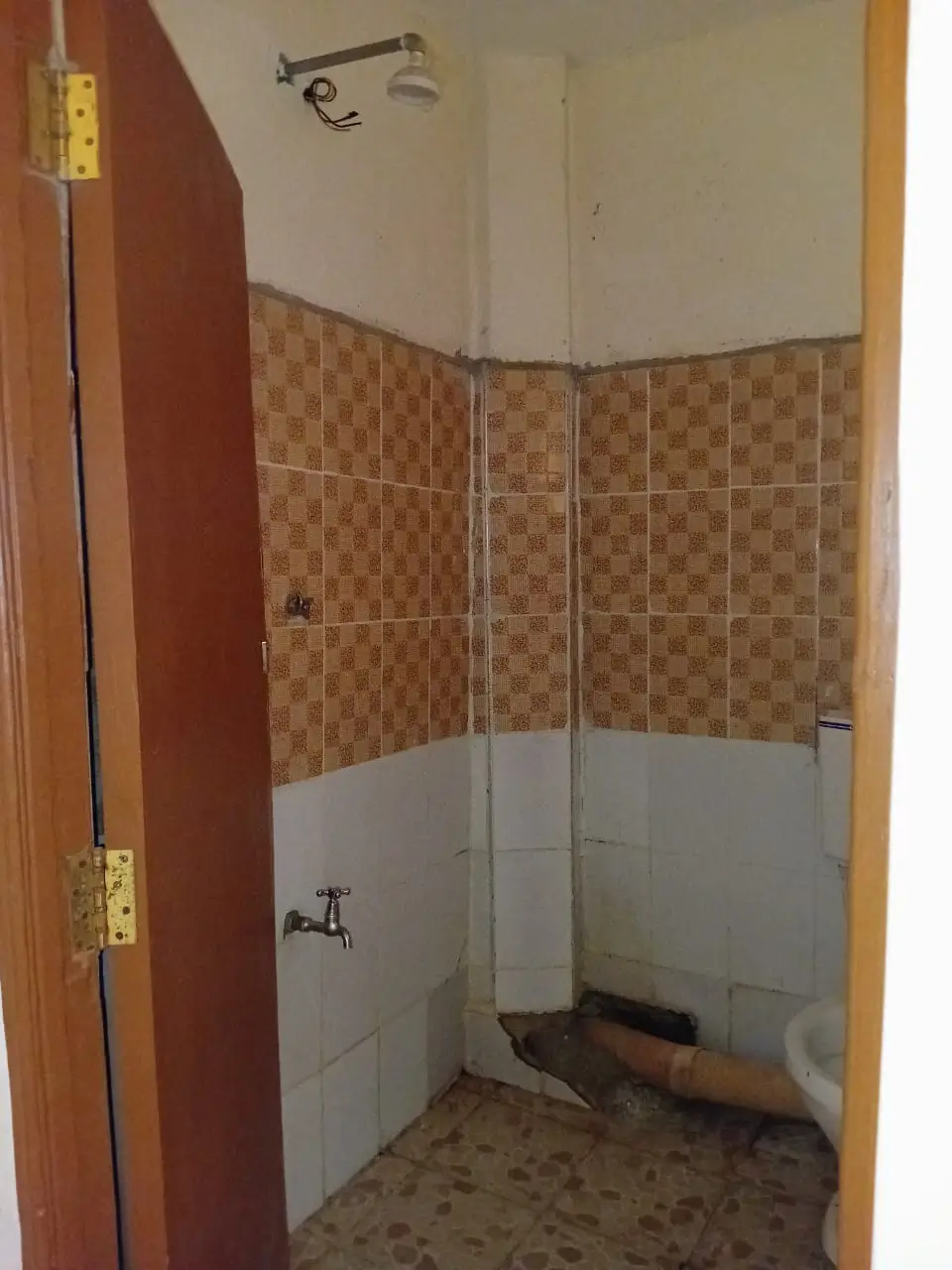 Small bathroom with patterned tiles and glass shower enclosure
