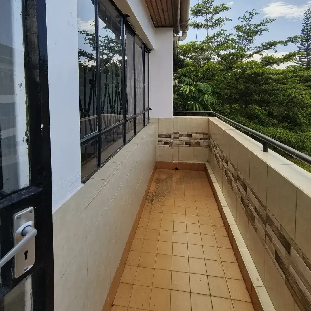Long narrow balcony with terracotta tiles, lush green views