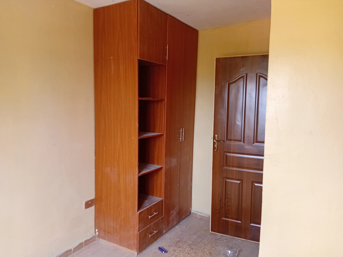 Bedroom with built-in wooden wardrobe and storage shelves