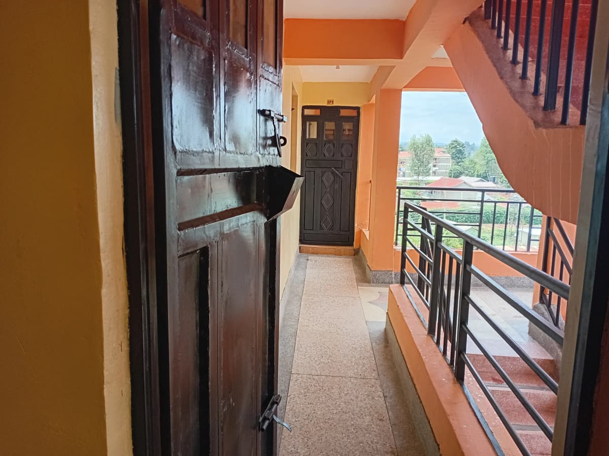Open balcony with railing overlooking green landscape and grounds