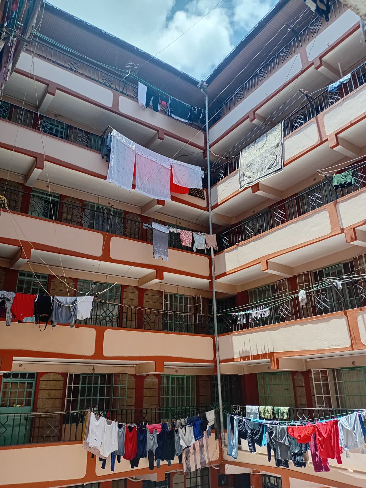 Multi-story residential building courtyard with laundry lines
