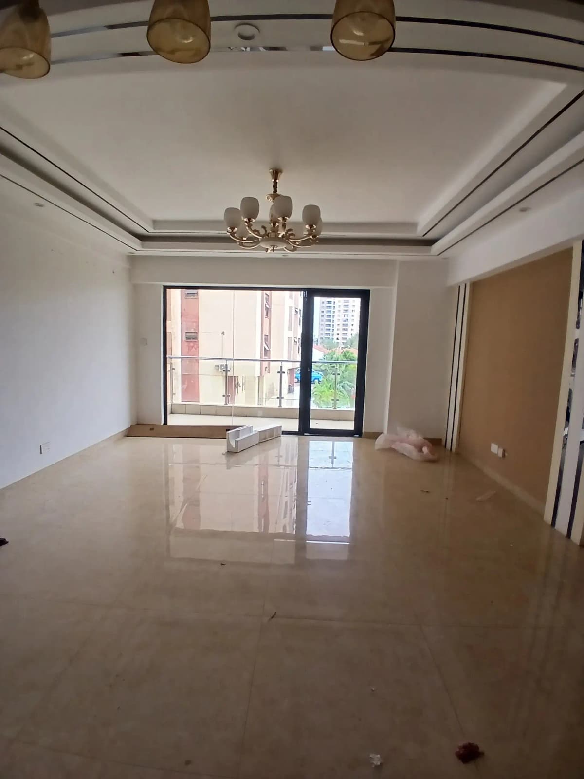 Spacious living room with decorative ceiling and city views