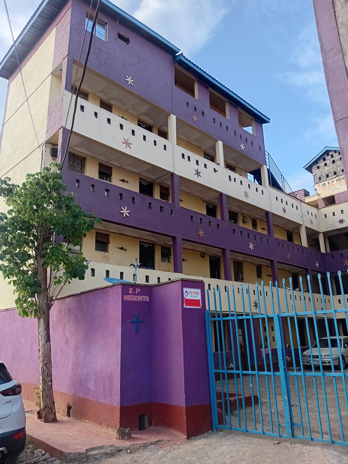 Multi-story residential building with purple and cream facade