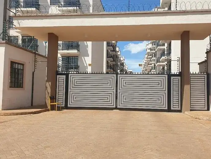 Gated driveway with metallic entrance gates and compound