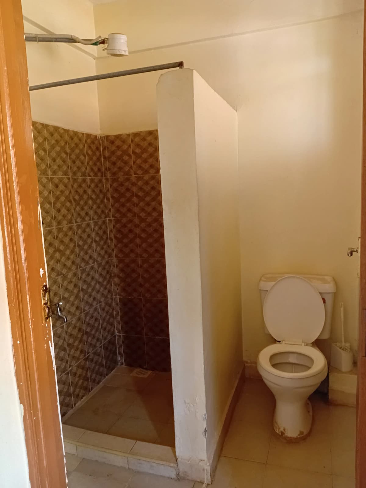 Compact bathroom with shower enclosure and toilet