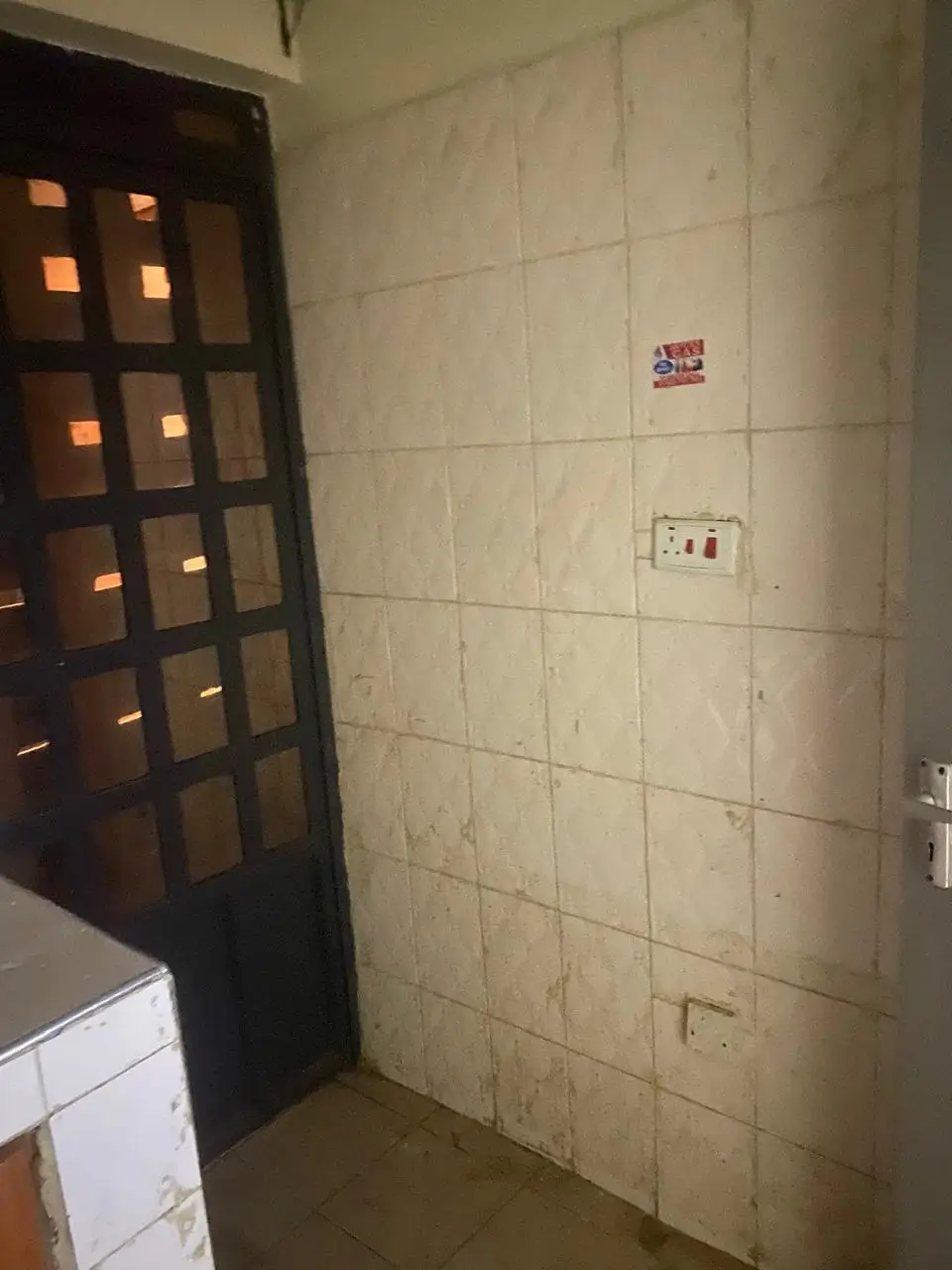 Bathroom with tiled walls and dark wooden door