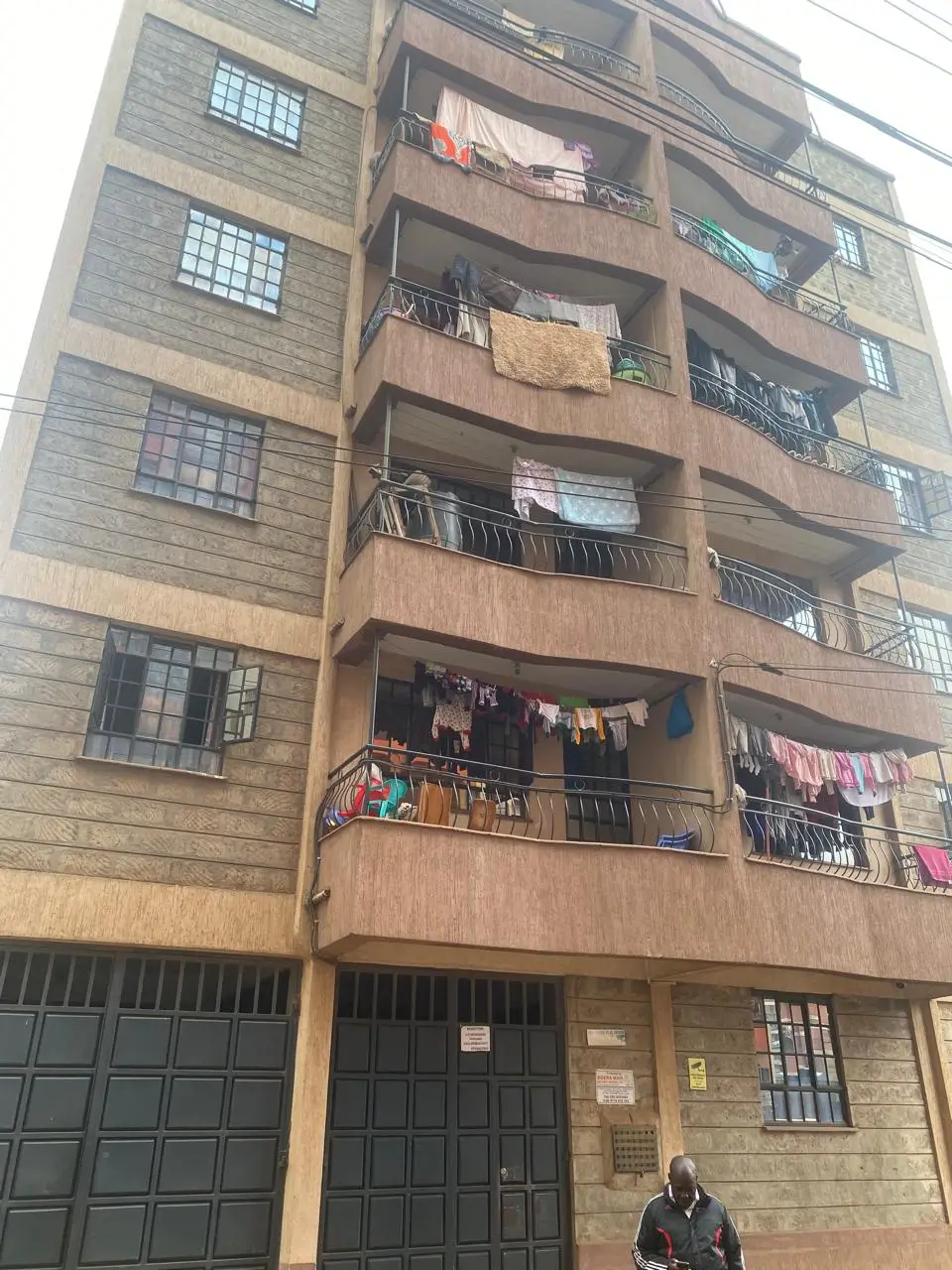 Multi-story residential building facade with balconies and laundry