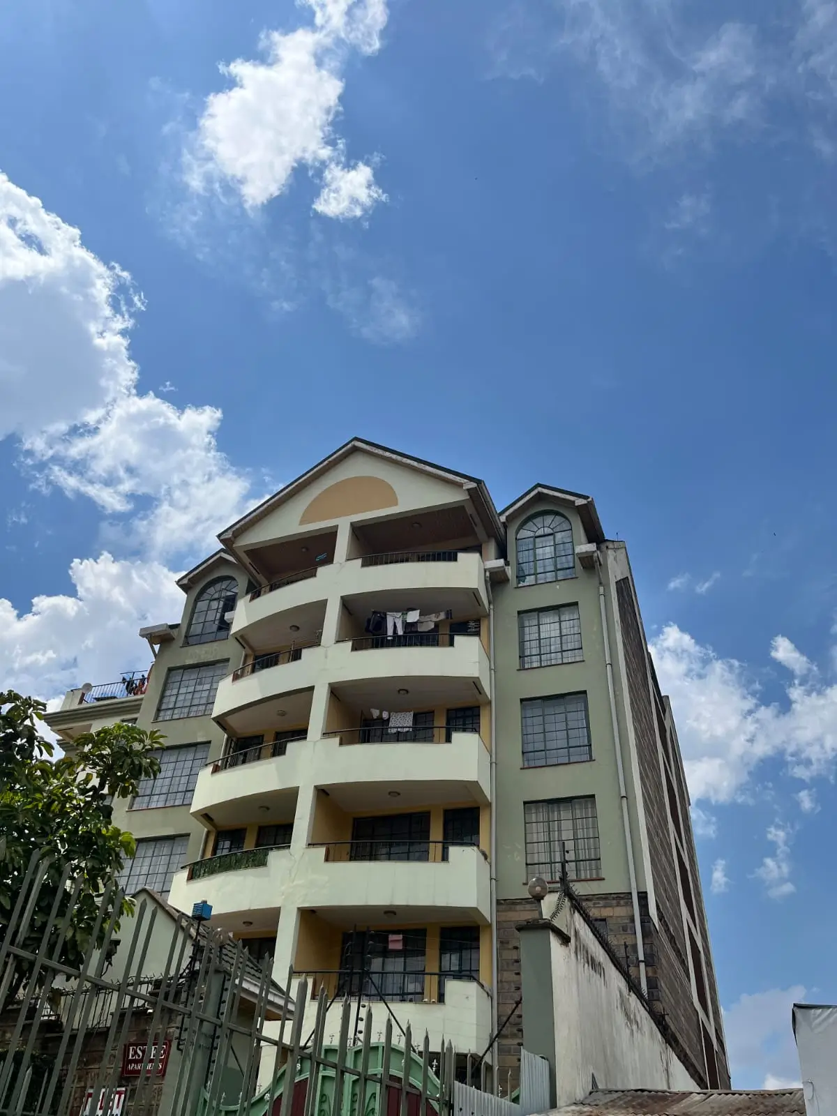 Modern multi-story residential building with curved balconies