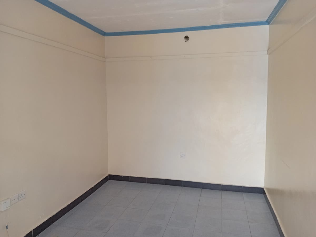 Empty bedroom with blue ceiling trim and dark floor