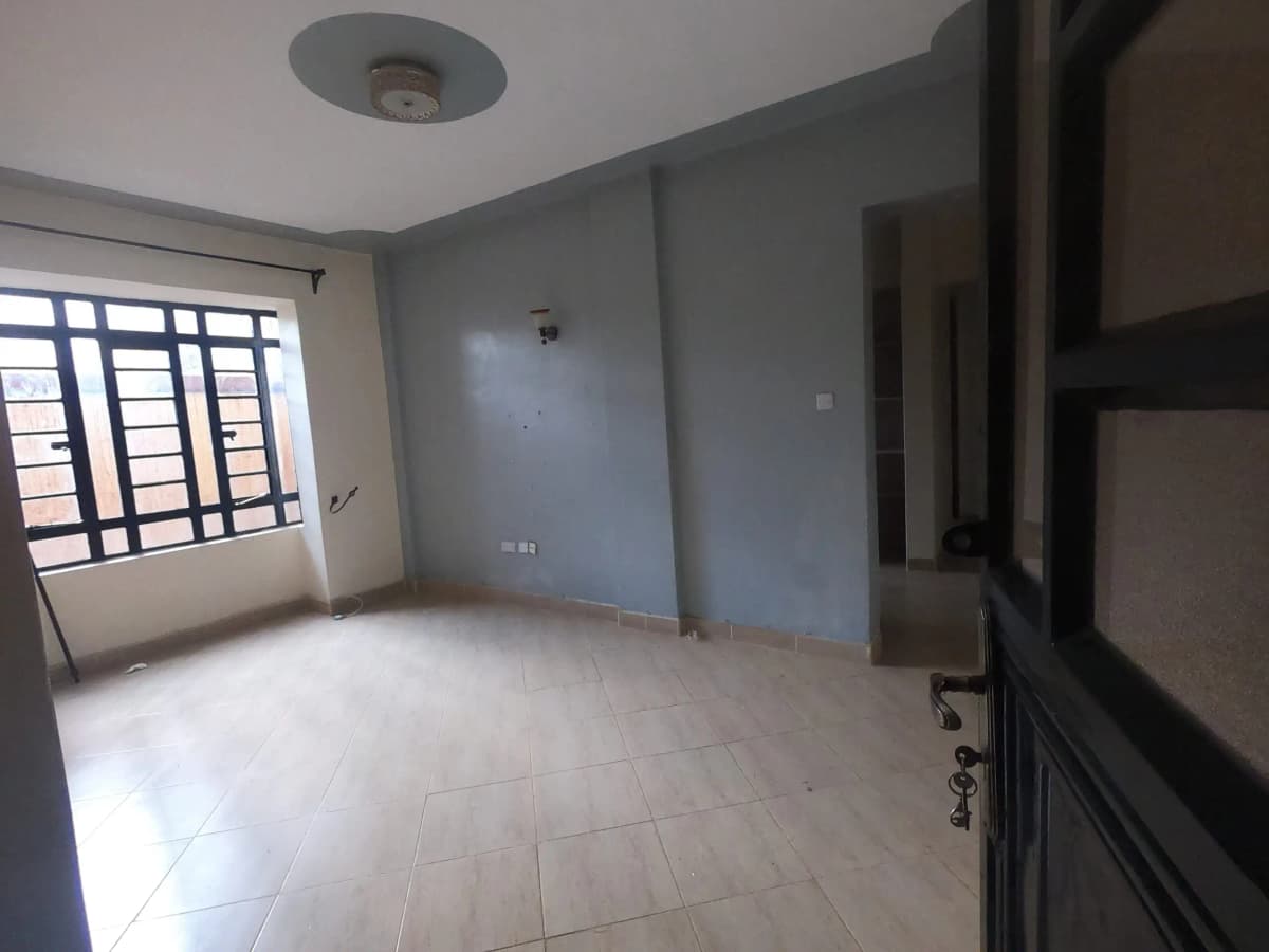Spacious living area with tiled floor and window access