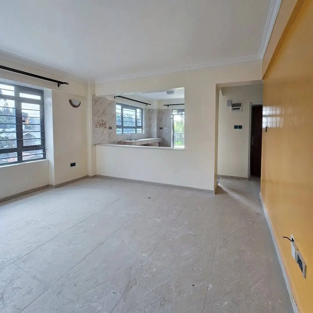 Open-plan living area with kitchen counter visible through window