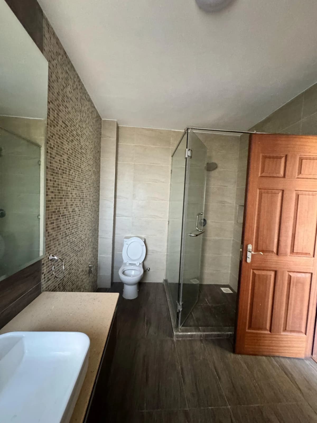 Modern bathroom with walk-in shower and dual vanity sinks