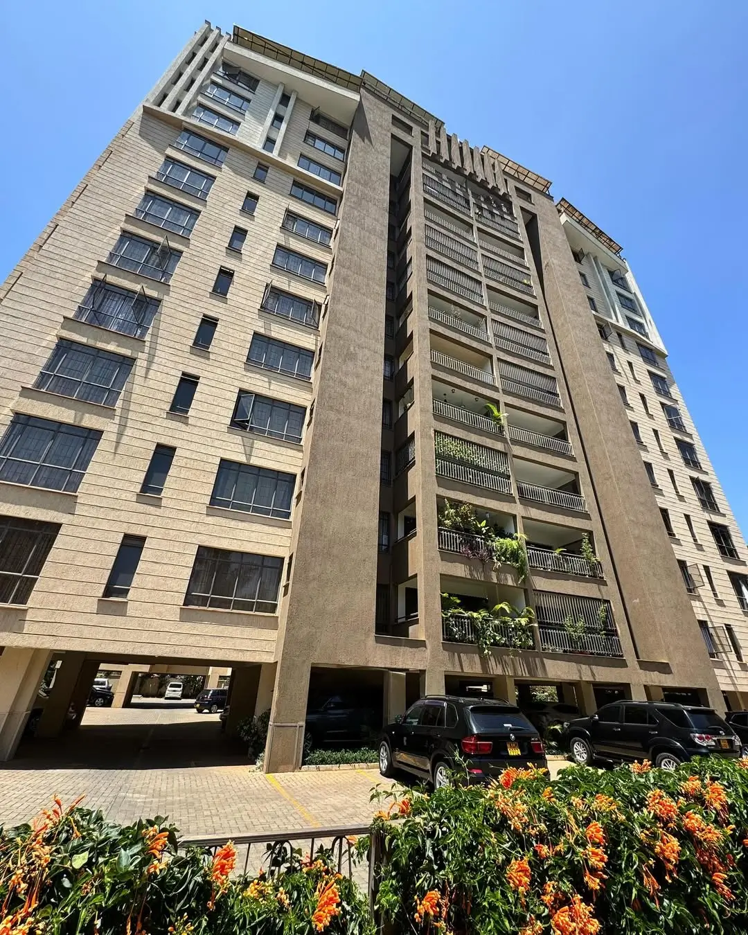 Modern mid-rise apartment building with ground-level parking