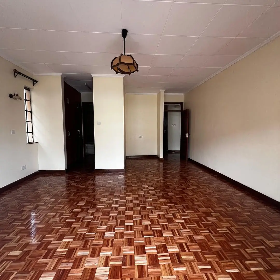 Spacious living room with parquet flooring and pendant light