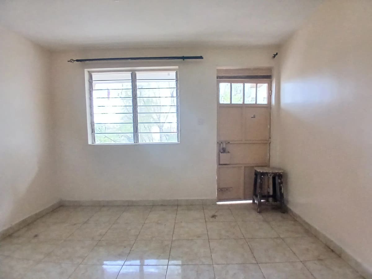 Bright empty living room with tiled floor and window access