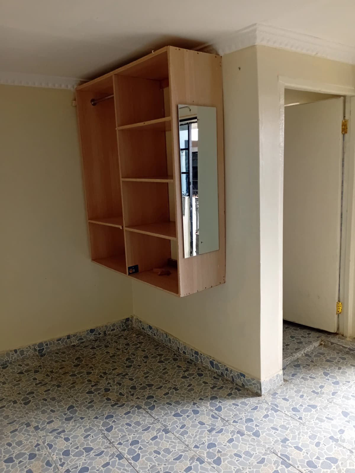 Kitchen with wooden wall-mounted cabinetry and terrazzo flooring