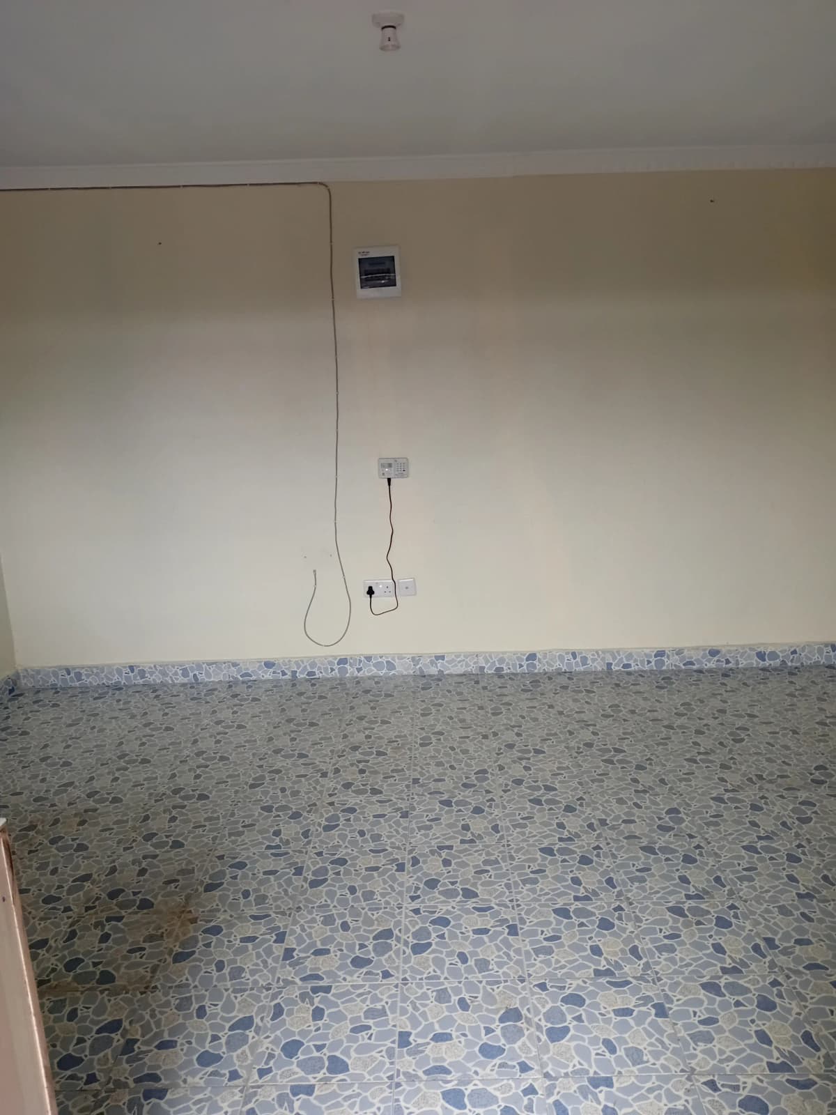 Empty bathroom with terrazzo flooring and basic fixtures installed