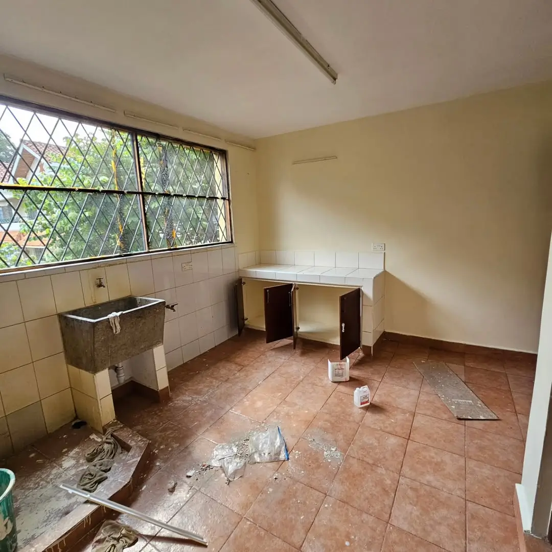 Utility room with sink and work bench, construction debris present