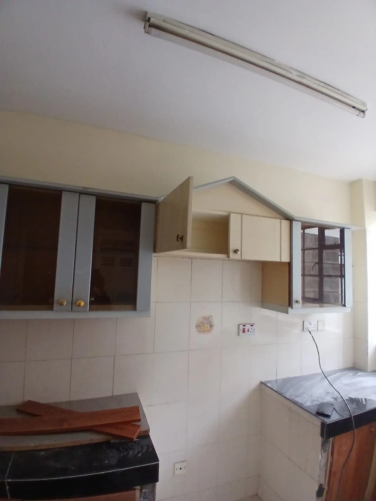 Compact kitchen with wall cabinets and basic appliances
