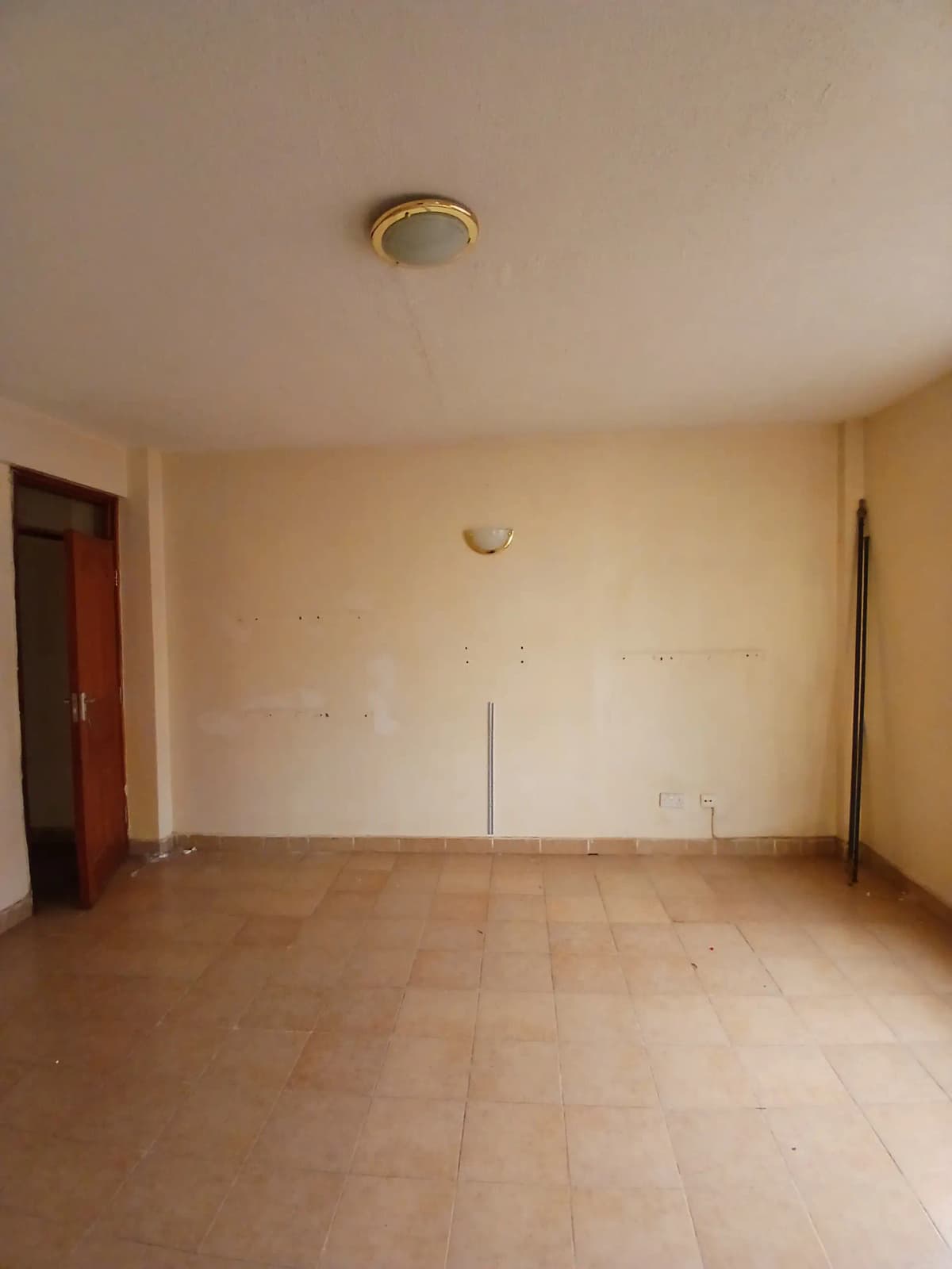Spacious empty living room with wooden flooring and neutral walls