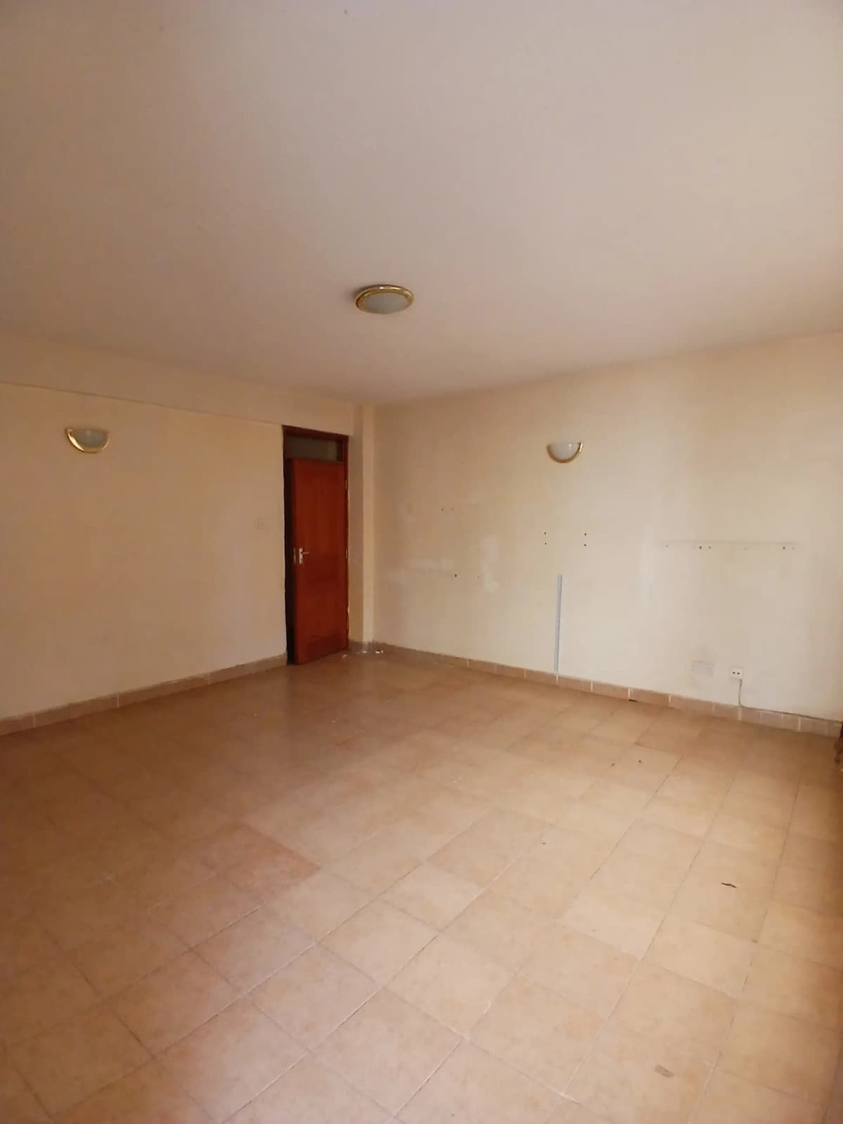 Spacious empty living room with terracotta tile flooring