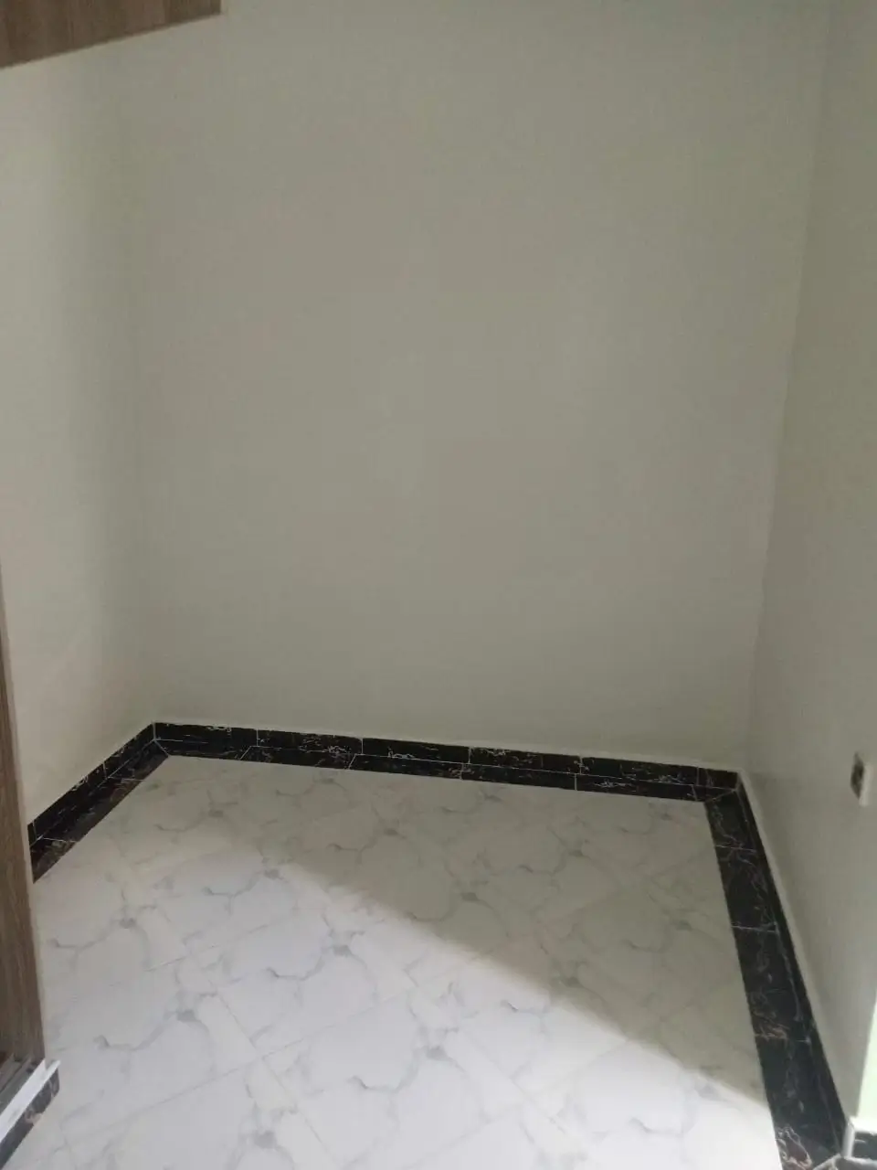 Bathroom with marble flooring and black trim baseboard