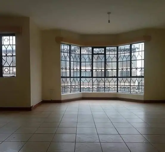 Spacious living room with bay windows and tiled flooring