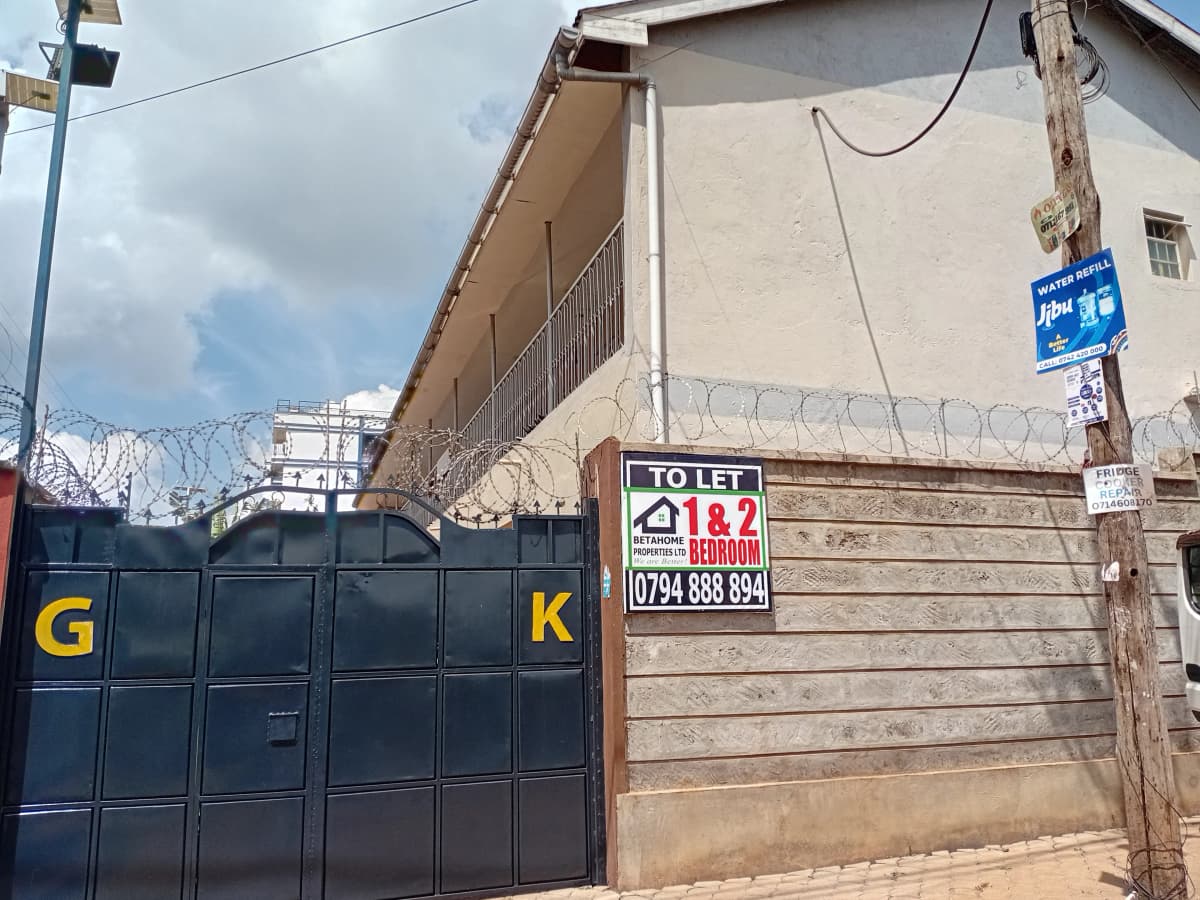 Compound gate and facade with rental signage visible