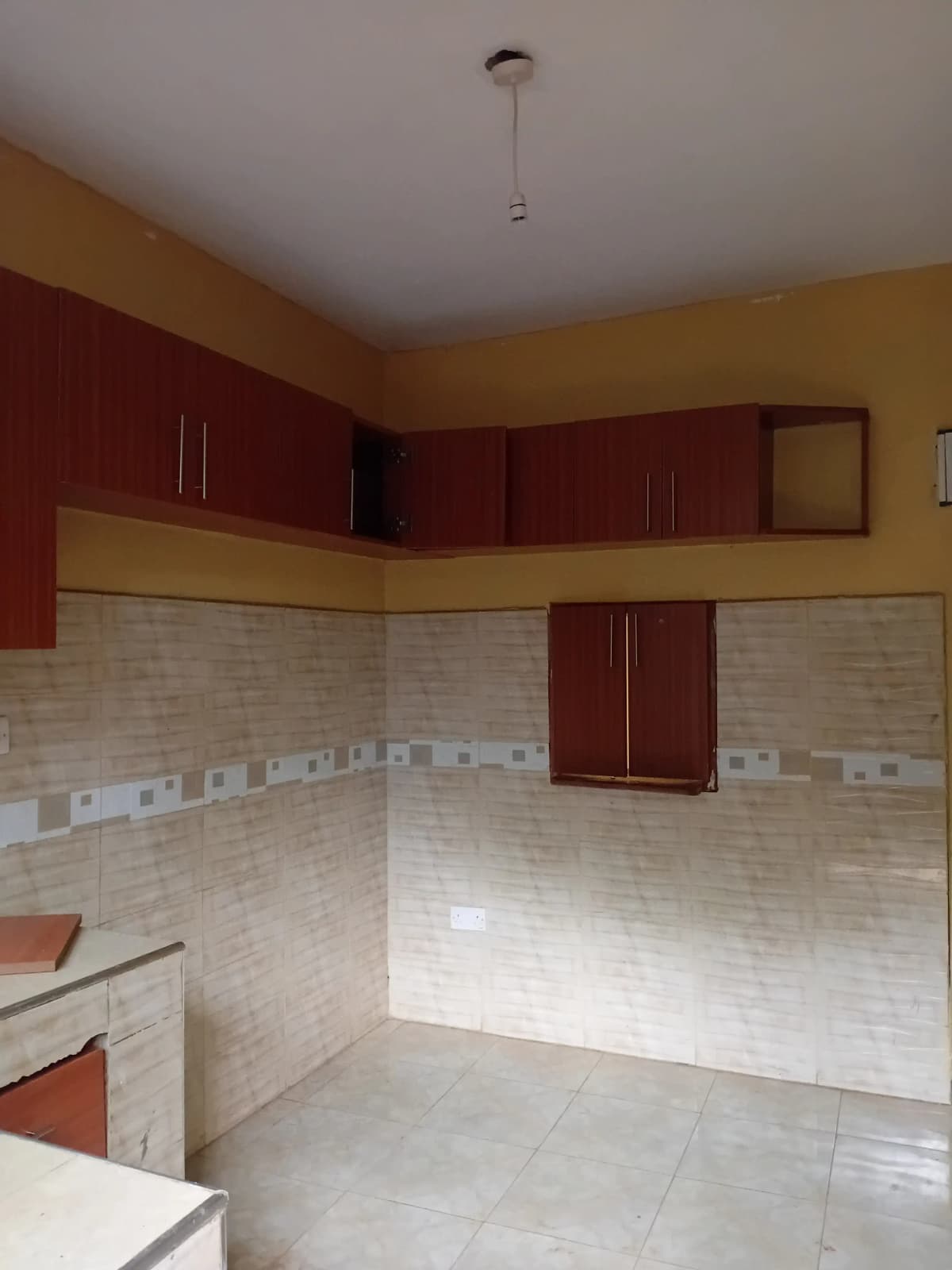 Modern kitchen with red cabinets and tiled backsplash