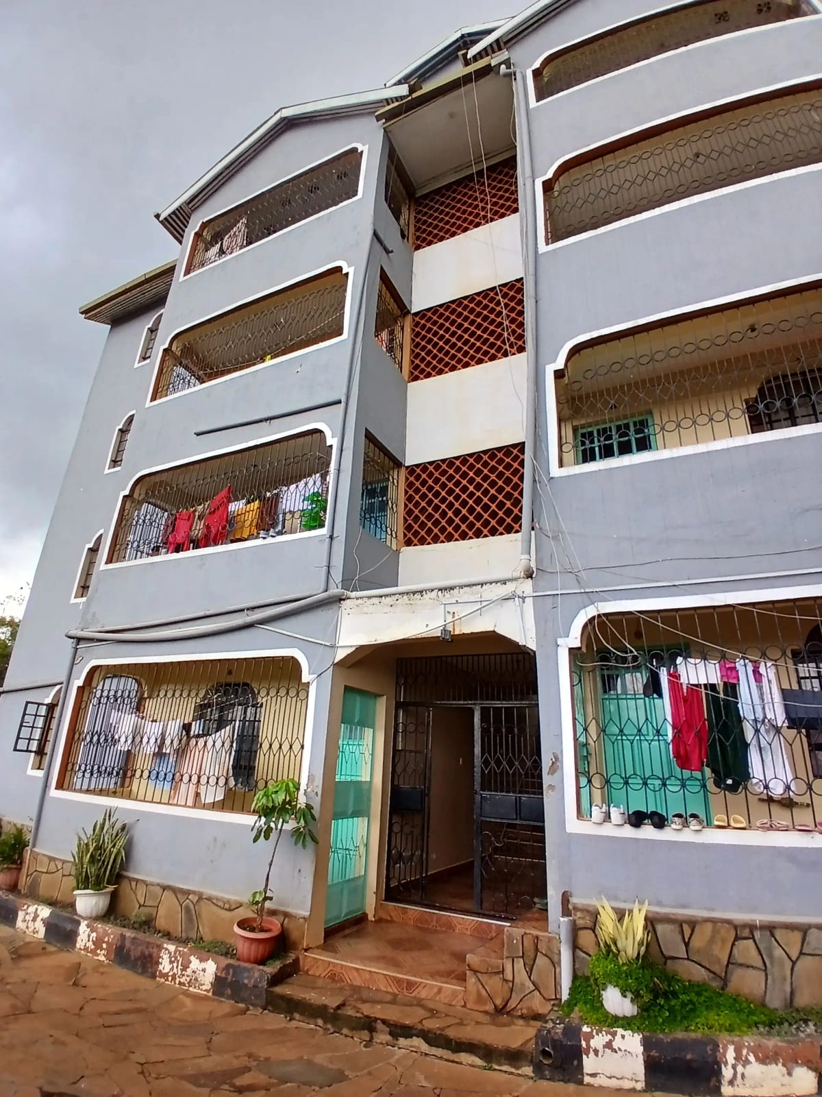 White residential building exterior with windows and clotheslines
