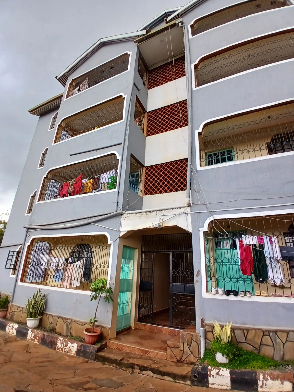 White residential building exterior with windows and clotheslines