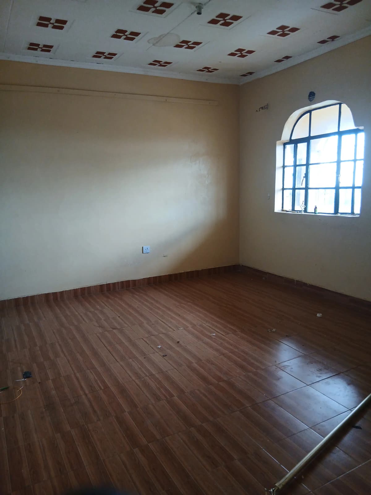 Empty room with tiled floors and window