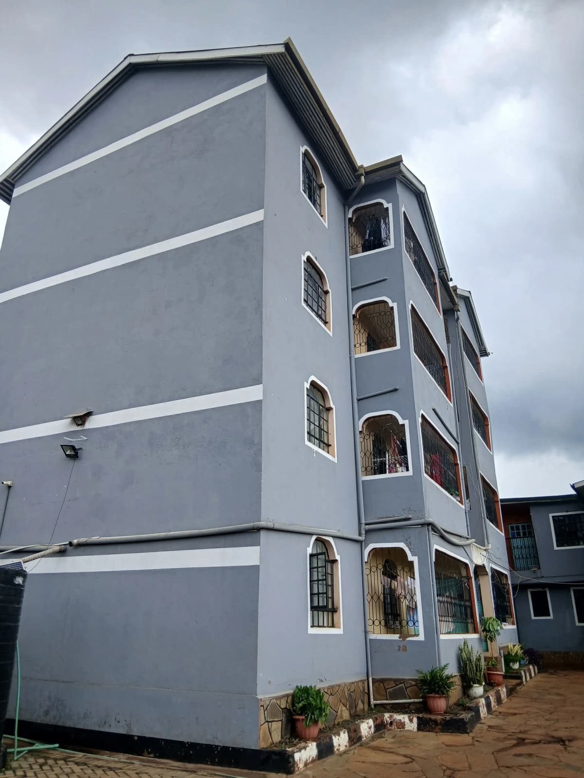 Modern multi-story residential building facade with white render.