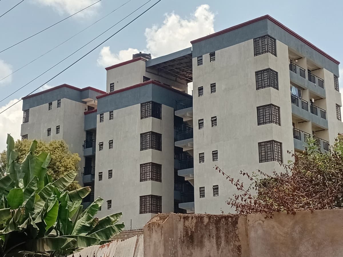 Multi-story residential apartment building with cream facade