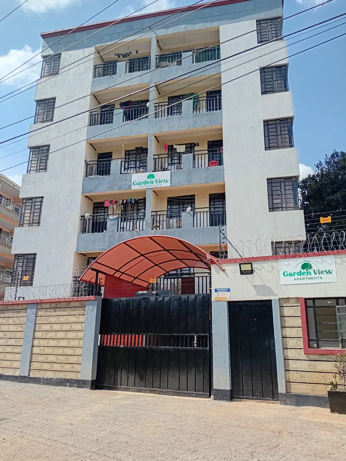 Multi-story residential building facade with ground-floor entrance gate