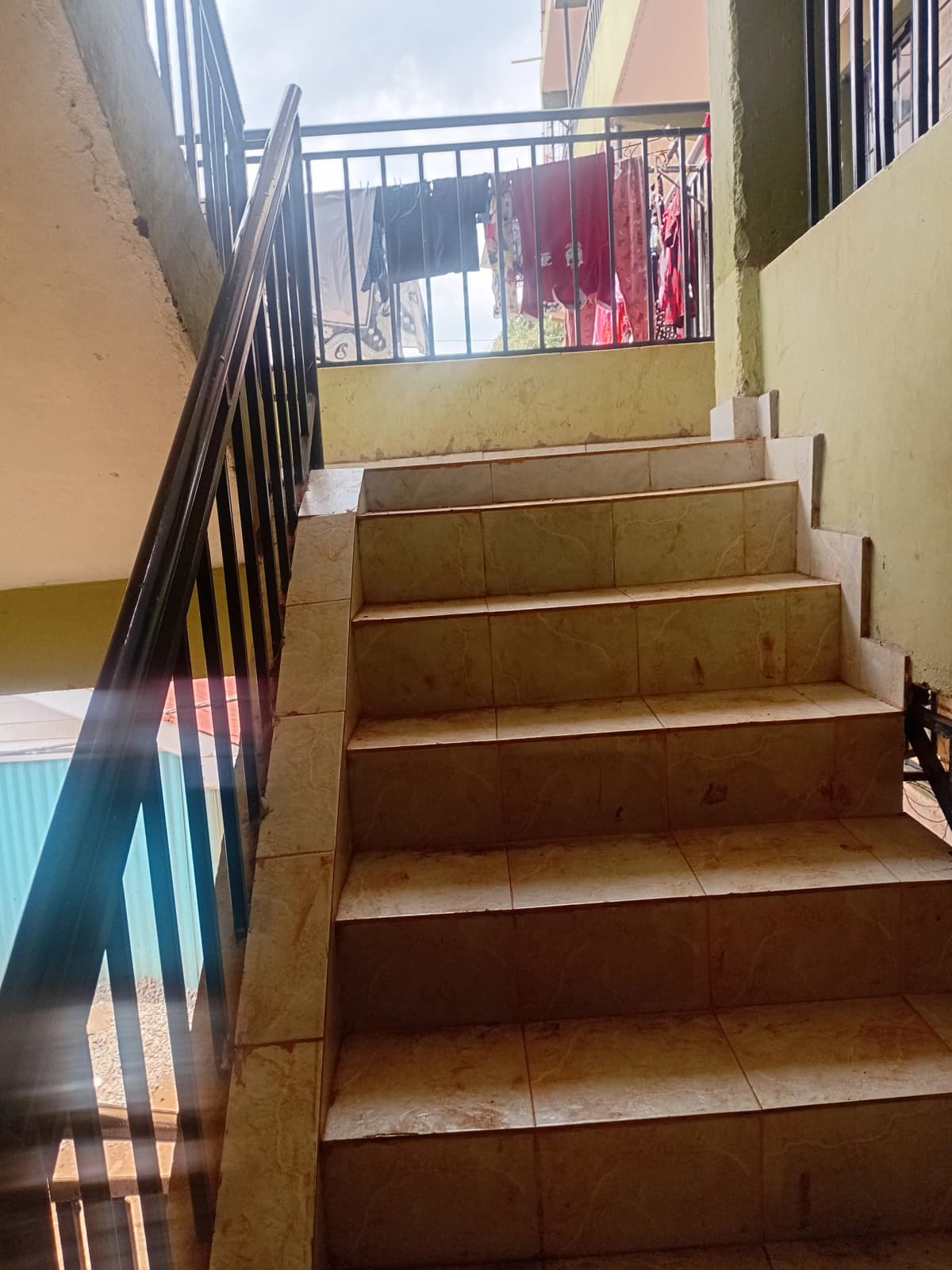 Internal staircase with metal railings and natural light