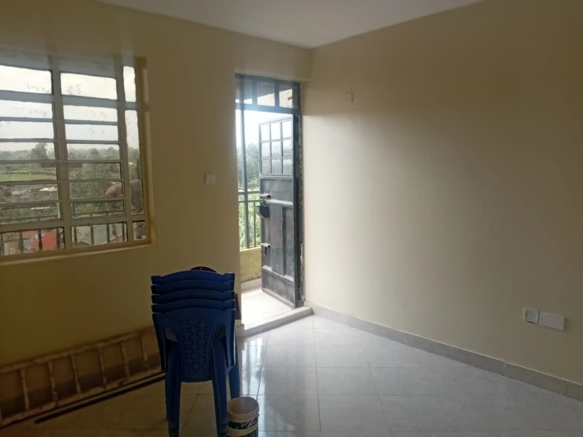 Bright balcony with open door and distant landscape view