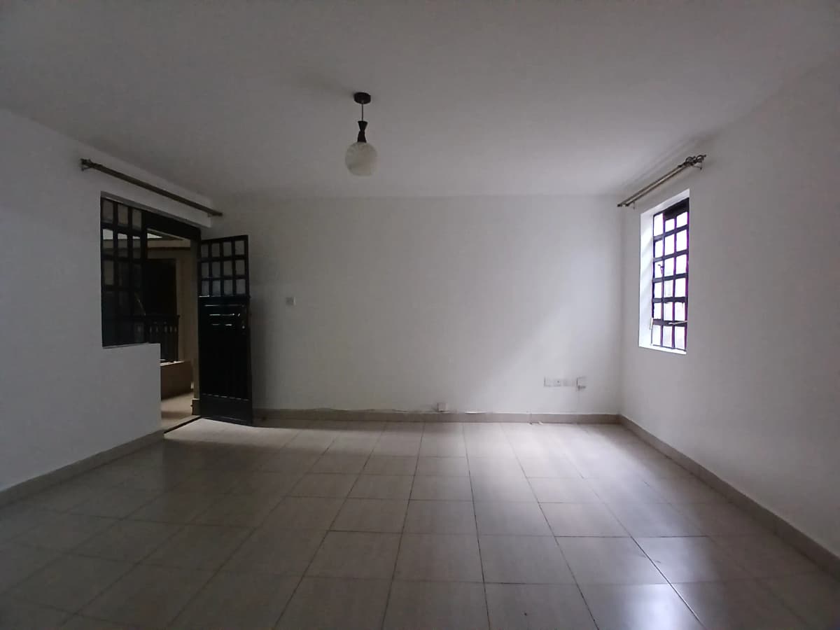 Spacious empty living room with natural light from window