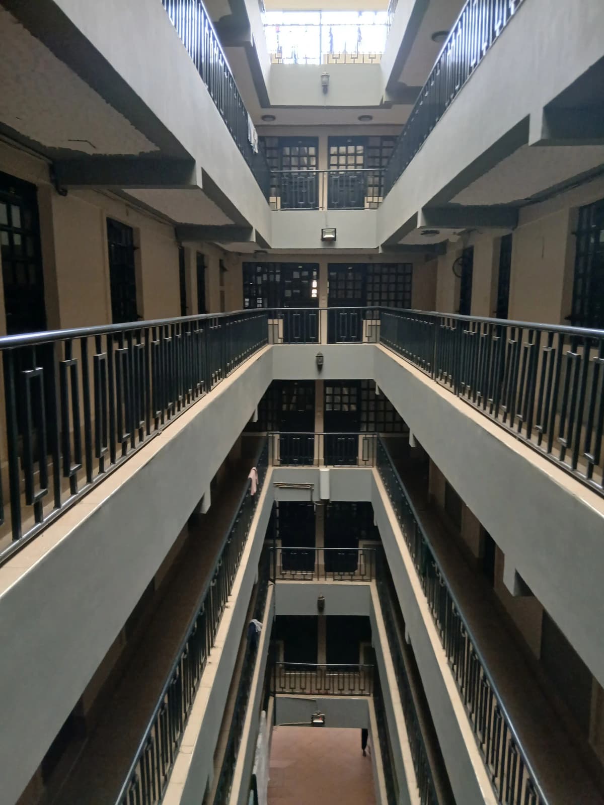 Multi-story atrium with metal railings and natural skylight