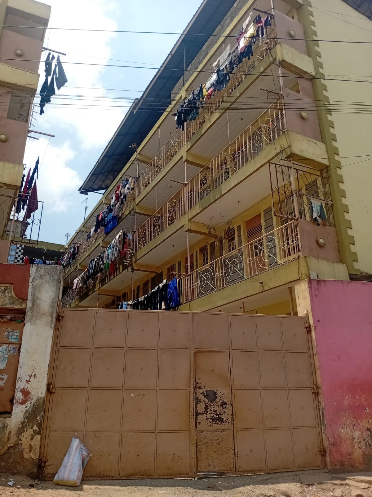 Multi-story residential building facade with metal gate entrance