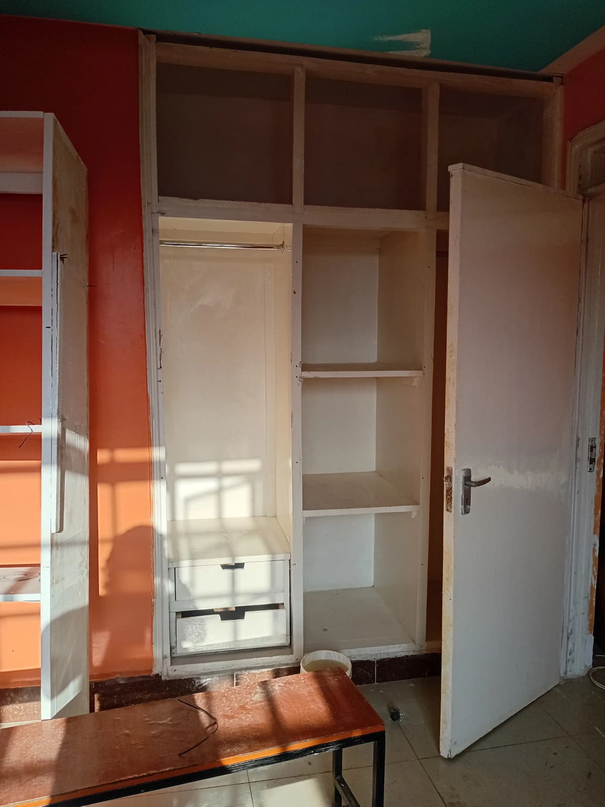 Bedroom with built-in wardrobe and open cabinet storage