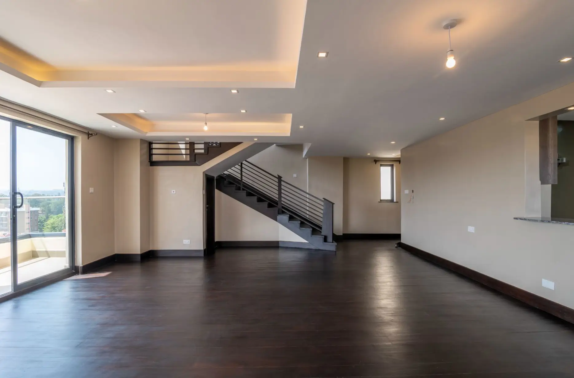 Spacious open-plan living area with staircase and natural light