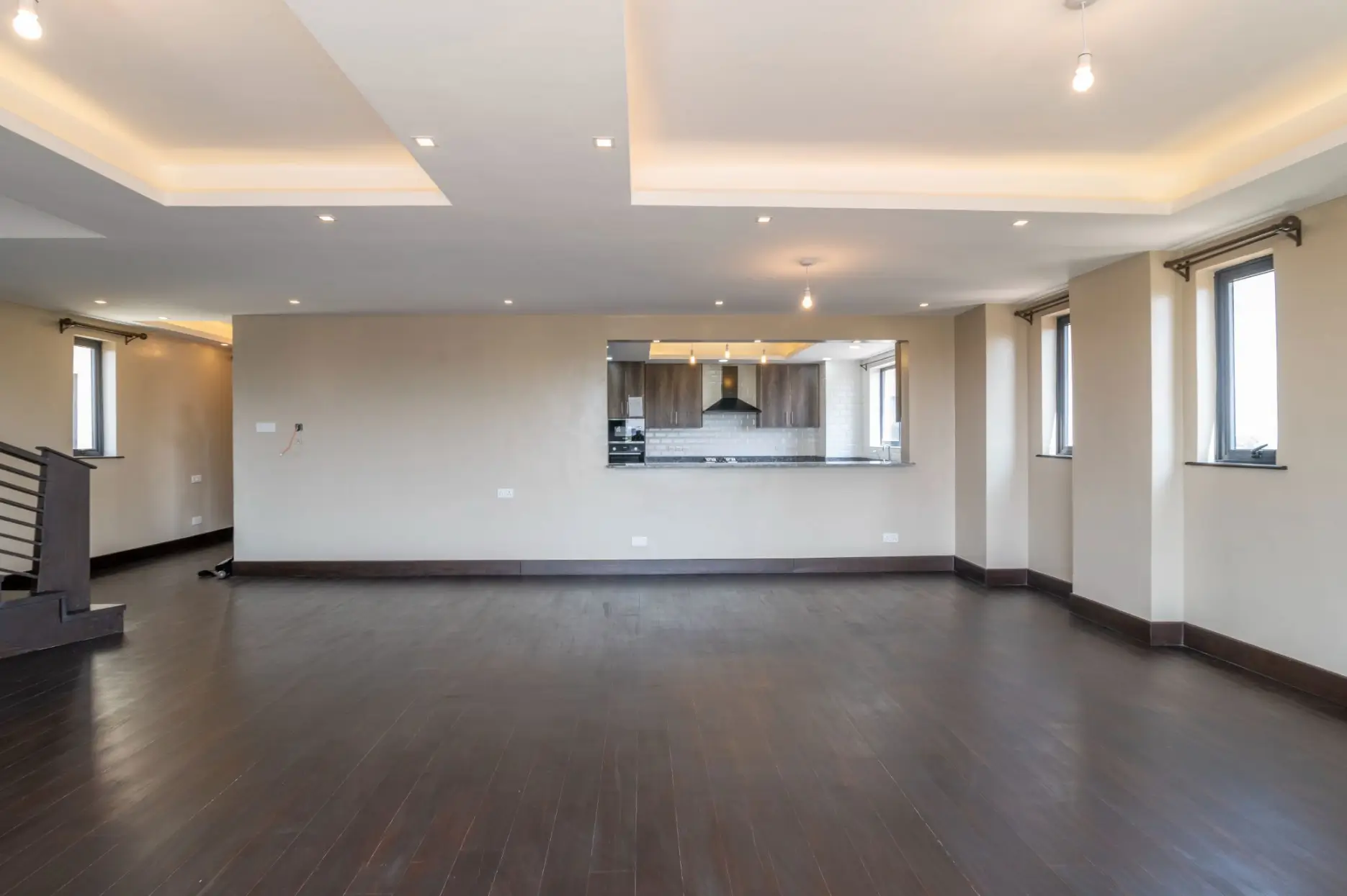 Open-plan living area with kitchen visible through pass-through window