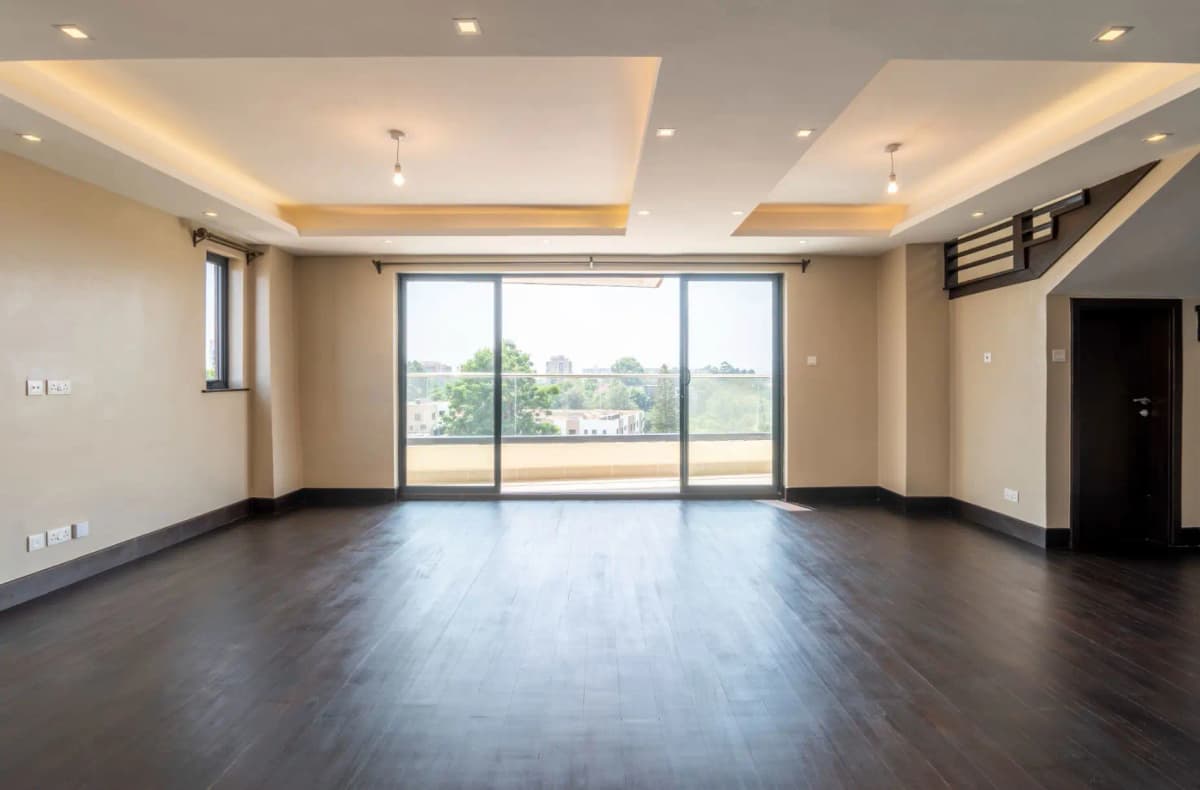 Spacious living room with large windows and city views