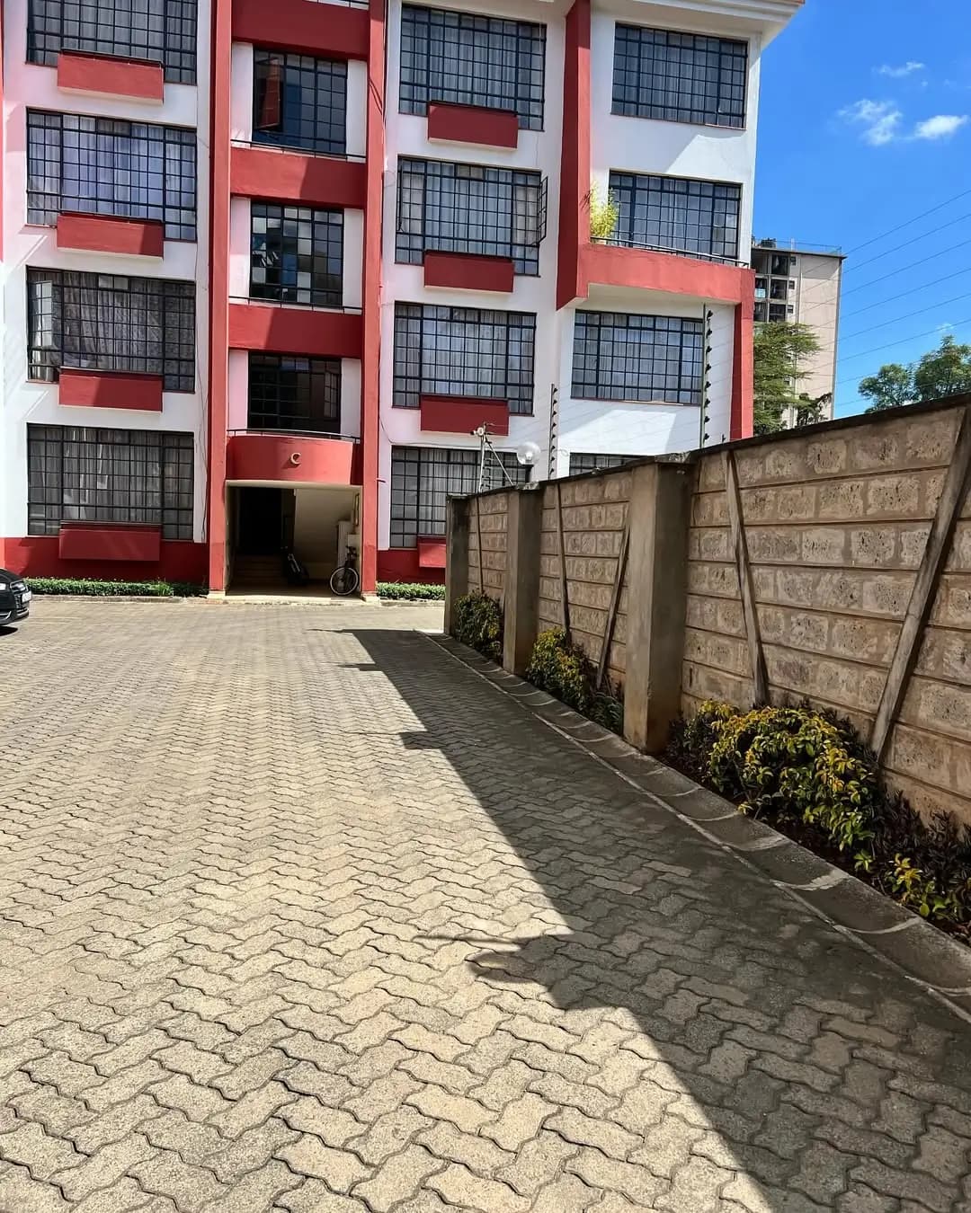 Modern apartment building facade with red and white accents