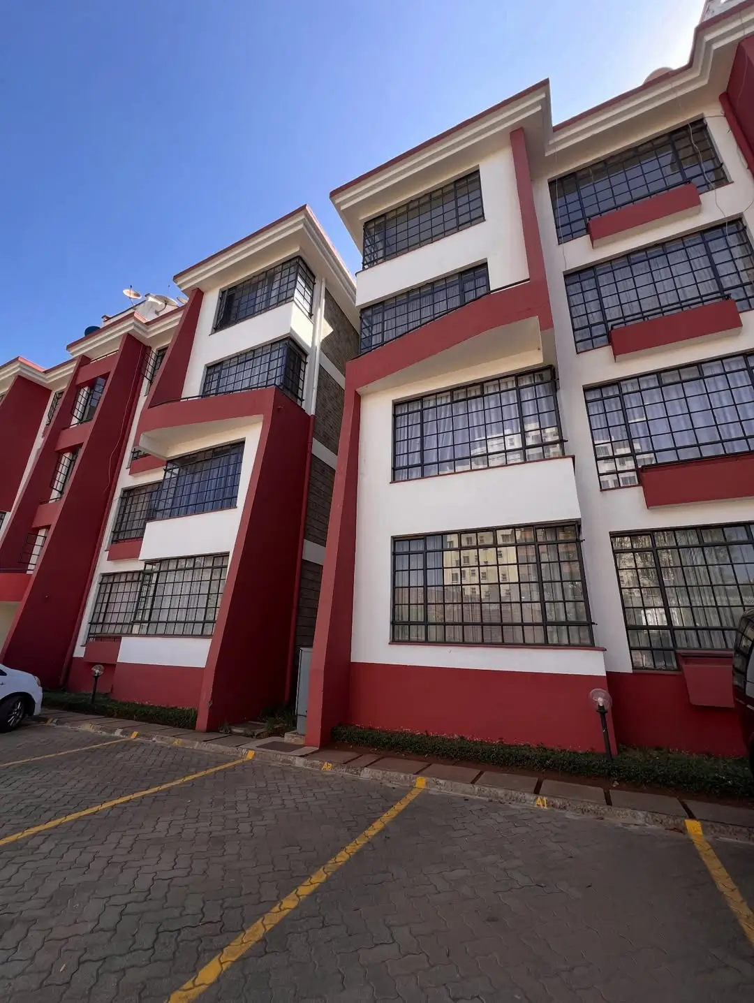 Multi-story residential building with red and white facade