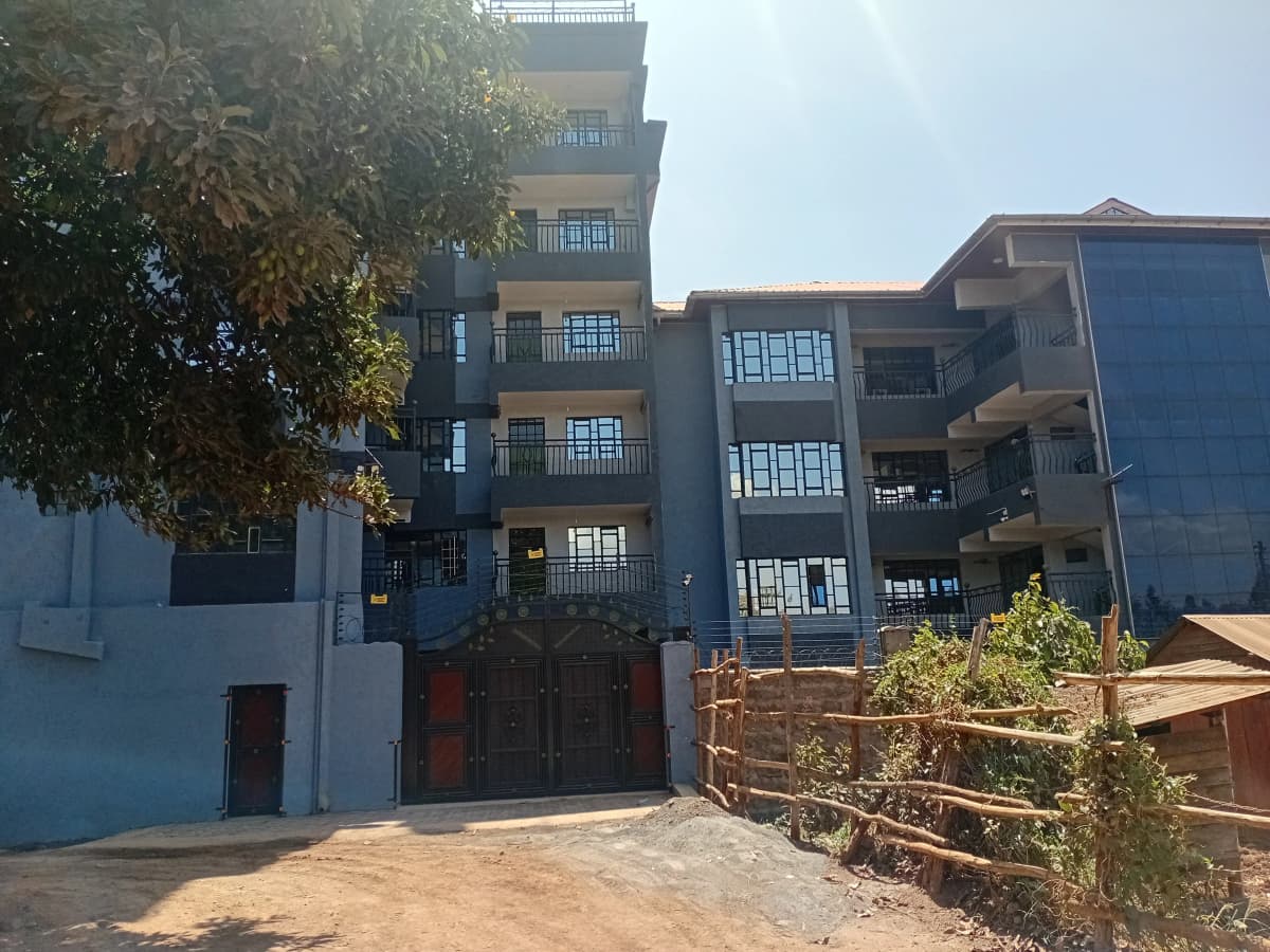 Multi-story residential building facade with blue and white painted exterior