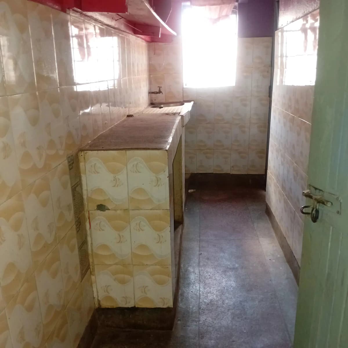 Compact kitchen with basic cabinetry and countertop space